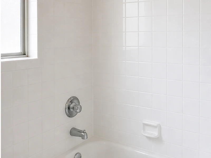 Reglazed tub-surround wall tile in a clean bright white with crisp grout lines in a Sunnyvale bathroom